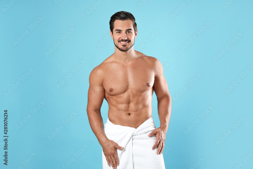 Fototapeta premium Young man with slim body on light blue background