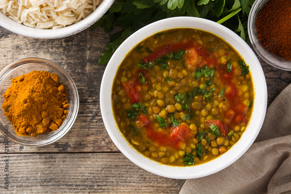 Indian lentil soup dal (dhal) in a bowl on wooden table. Top view Indian lentil soup dal (dhal) in a bowl on wooden table. Top view