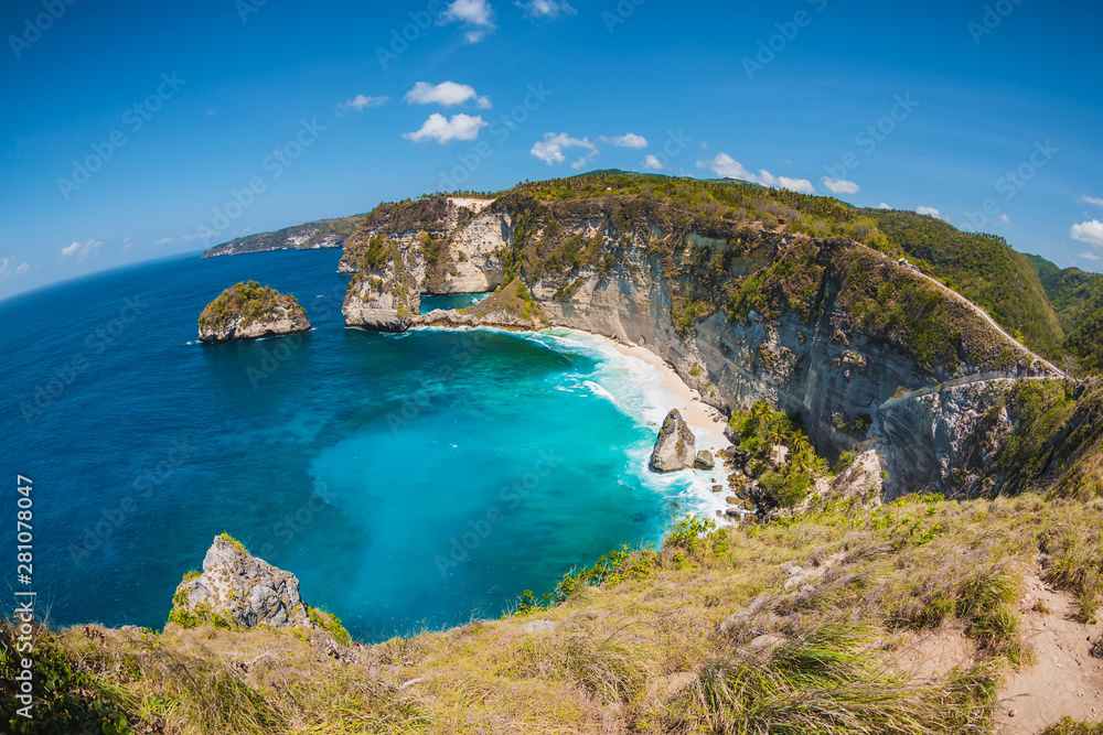 Amazing view of Diamond beach with coconut palms and rocks in Nusa Penida