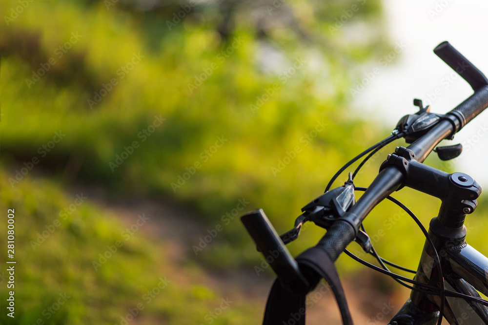 Close-up of mountain bike in the forest at sunset with copyspace Close-up of mountain bike in the forest at sunset with copyspace