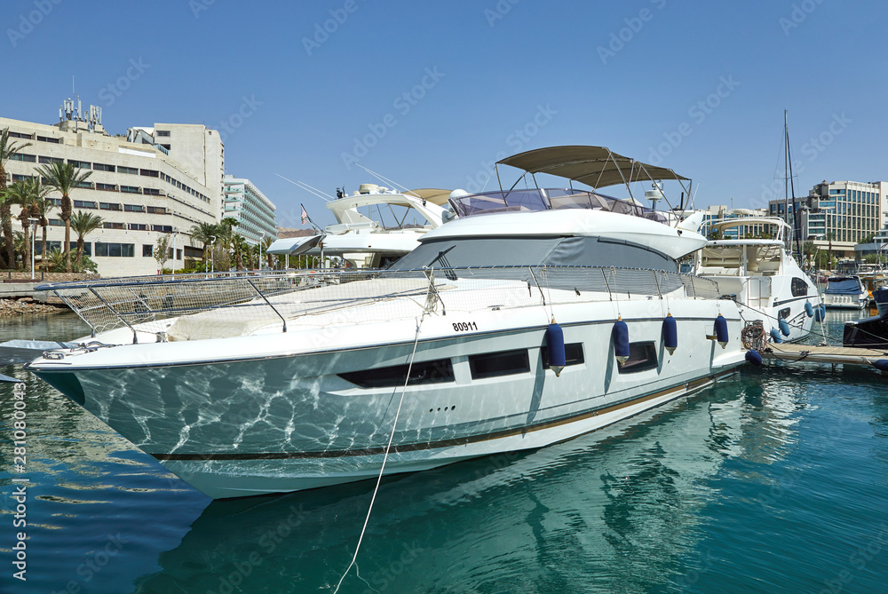 View of the Gulf of Eilat with luxury yachts. On the yacht you can sunbathe, jump into the open sea and enjoy drinks and fruits.