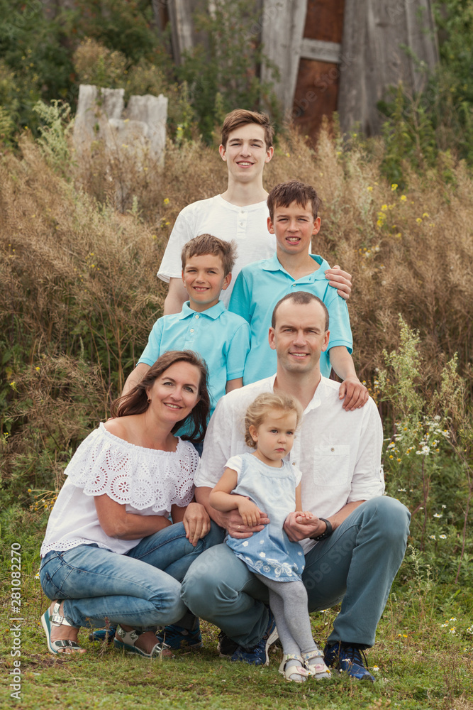 Big Happy Family. Parents with four children in countryside outdoors