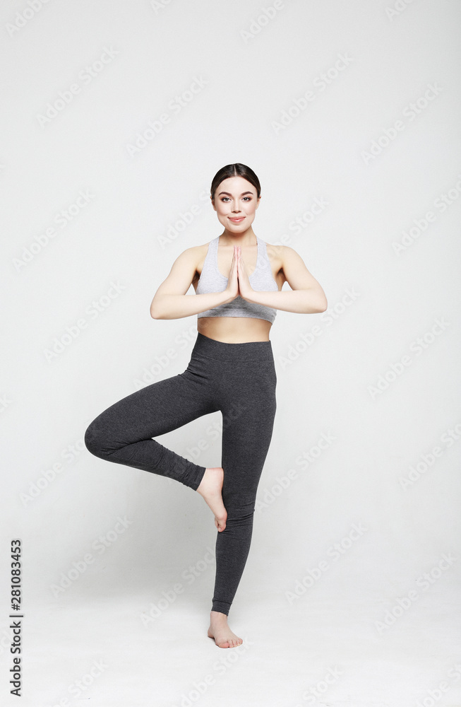 Obraz premium Portrait of attractive woman doing yoga, pilates. Healthy lifestyle and sports concept.