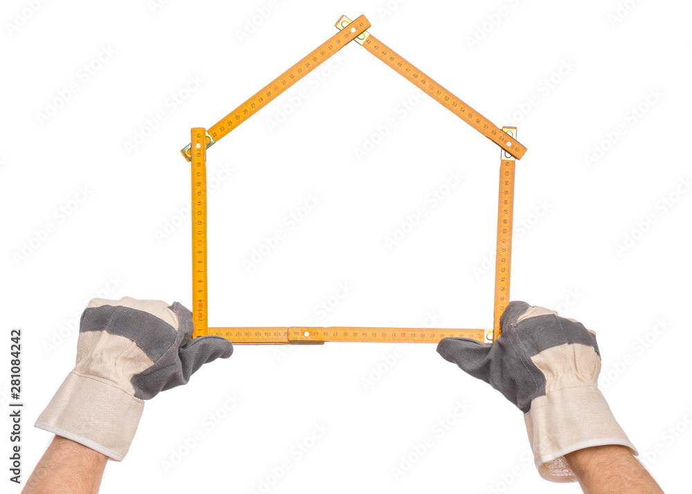 Male Hand wearing Working Glove with yellow wooden meter. Human Hand holding tool forming a house, Isolated on White Background. - obrazy, fototapety, plakaty 