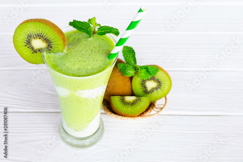 Kiwi yogurt juice healthy smoothies green beverage taste delicious drink summer have proten colorful in the glass and fruit kiwi on white wood background.