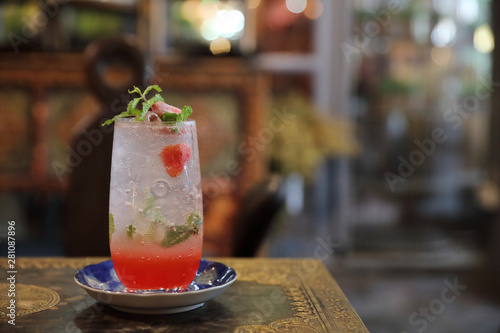 Strawberry mojito cocktail drink on wood background