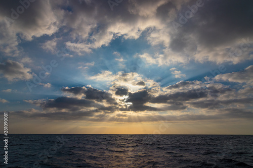 Impressive sunbeams in a cloud. The picture is taken from the sea in Tenerife Spain.