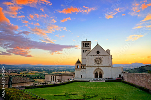 Basilica of San Francis of Assisi at sunset under beautiful glowing orange and blue skies, Italy photo