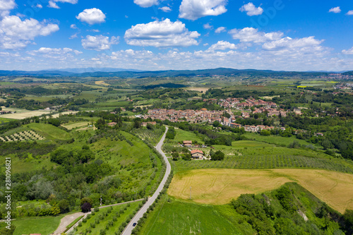 Rolling hills of Tuscany  Italy  on a sunny summers day. A paved road runs through the country landscape.