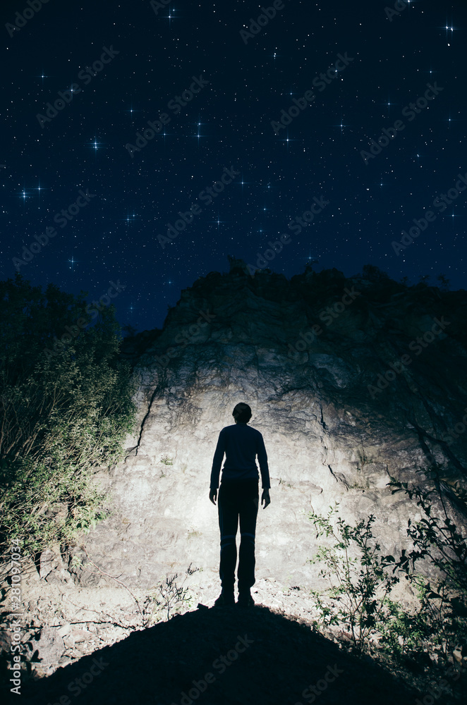Silhouette of man standing on rock against starry sky Silhouette of man standing on rock against starry sky