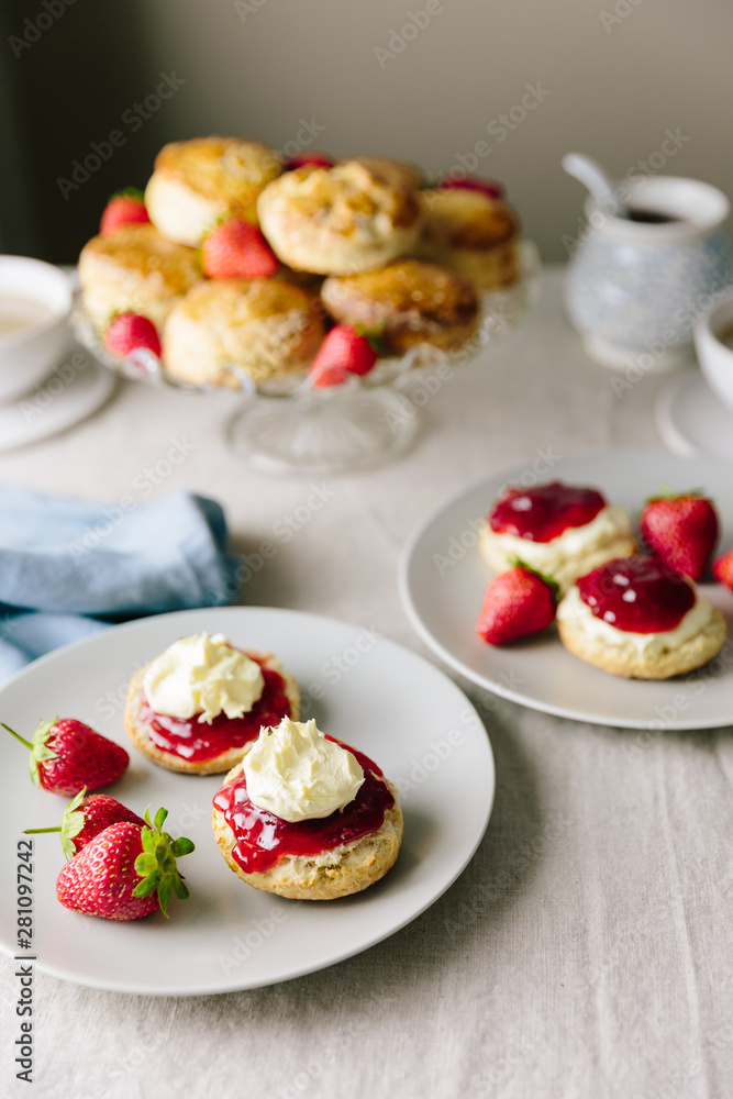 Cornish and Devonshire style scones with jam and cream opposite Cornish and Devonshire style scones with jam and cream opposite