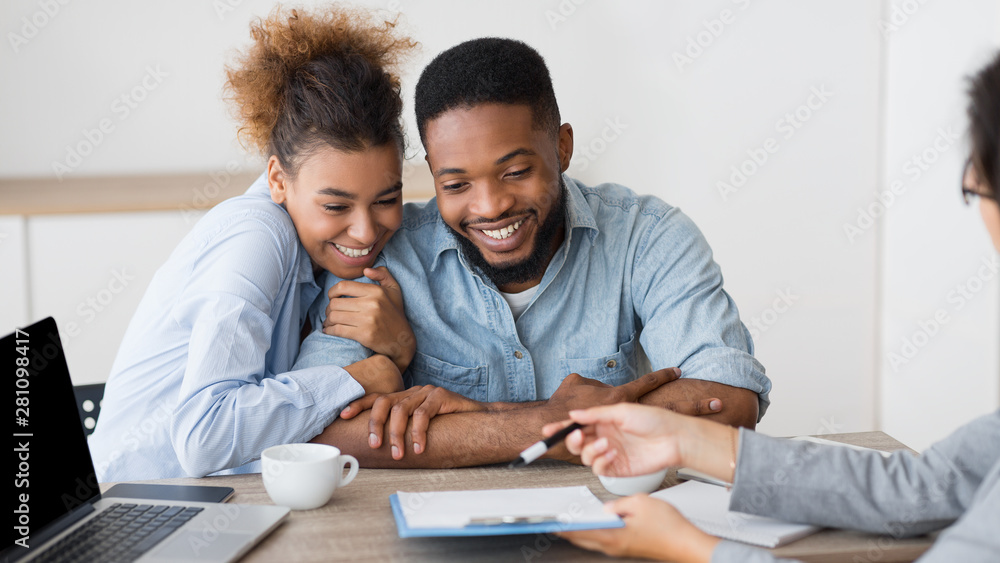 Excited Afro Spouses Planning Vacation In Travel Agency Office Excited Afro Spouses Planning Vacation In Travel Agency Office