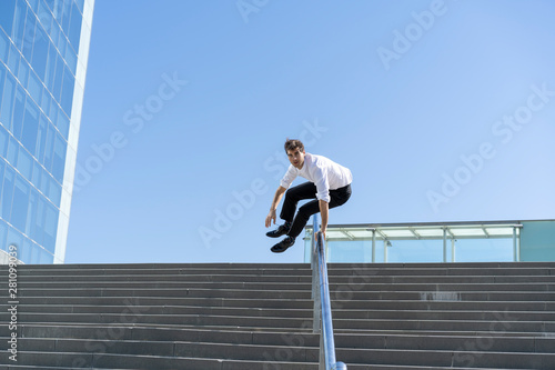 Businessman crossing banister in the city photo