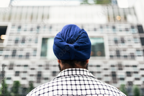 Rear view of man wearing a blue Sikh style turban or dastar photo