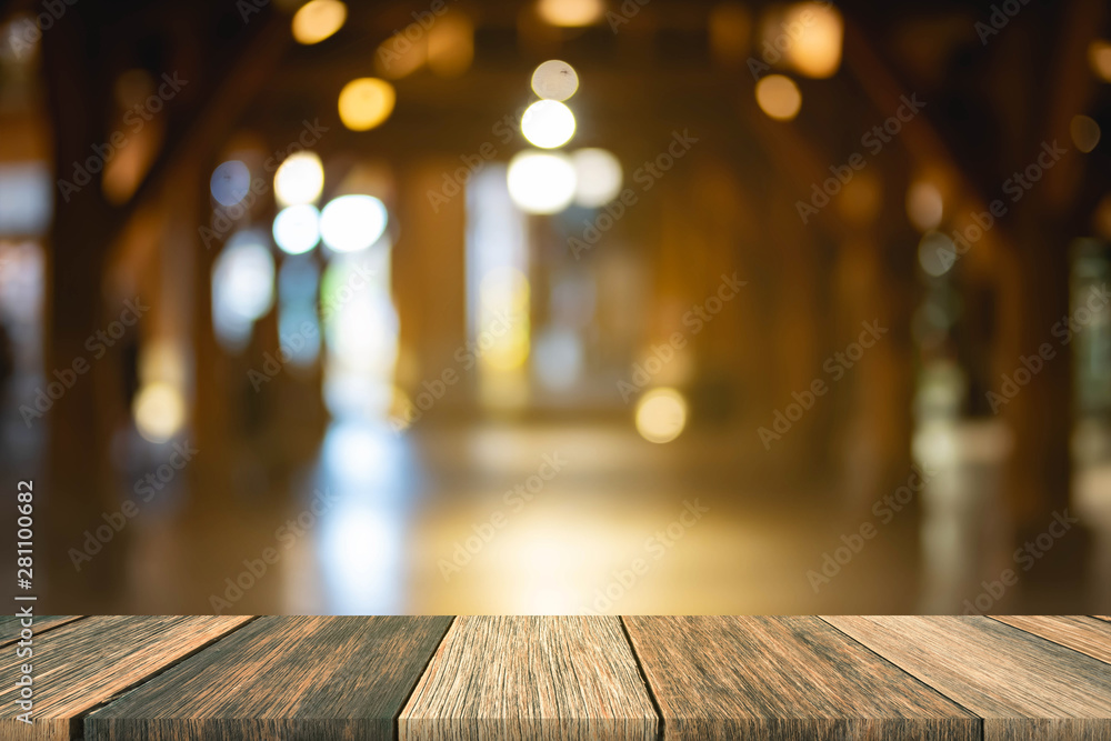 Blurred wooden table in front blurred night street market with bokeh abstract background, copy space for presentation product