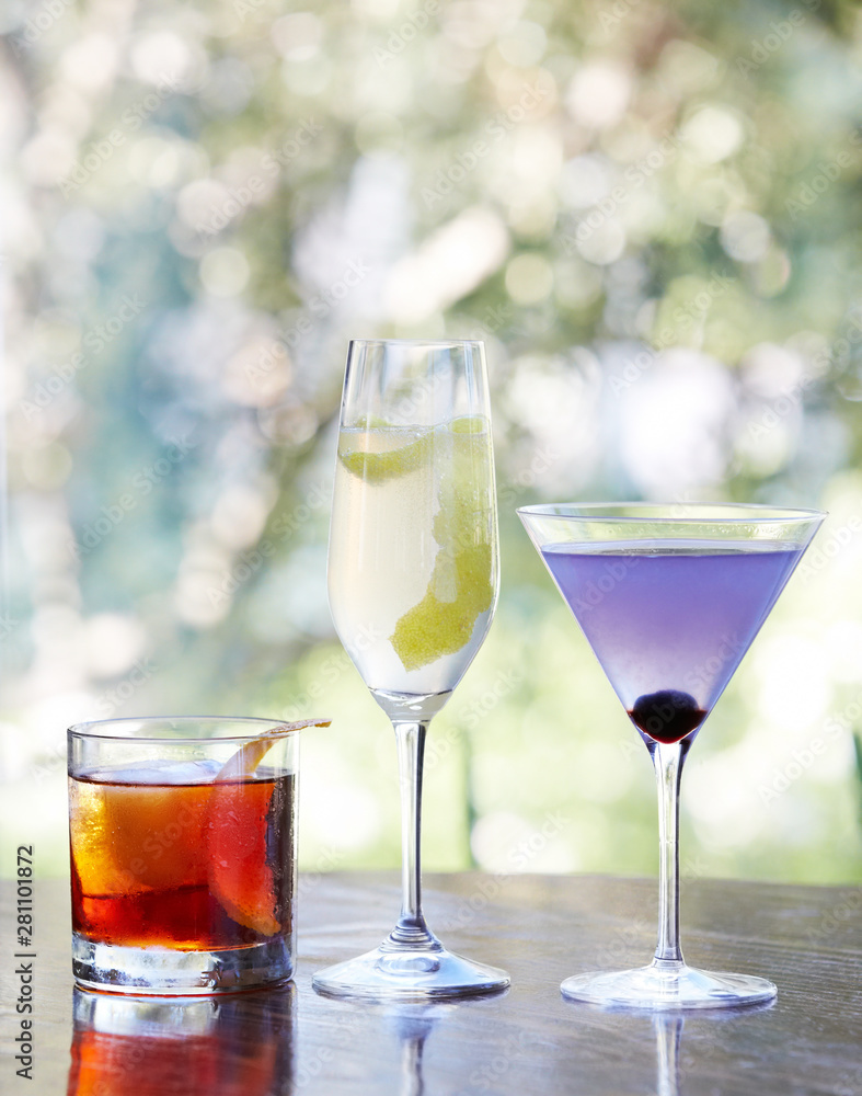 Three mixed drinks on bar Three mixed drinks on bar