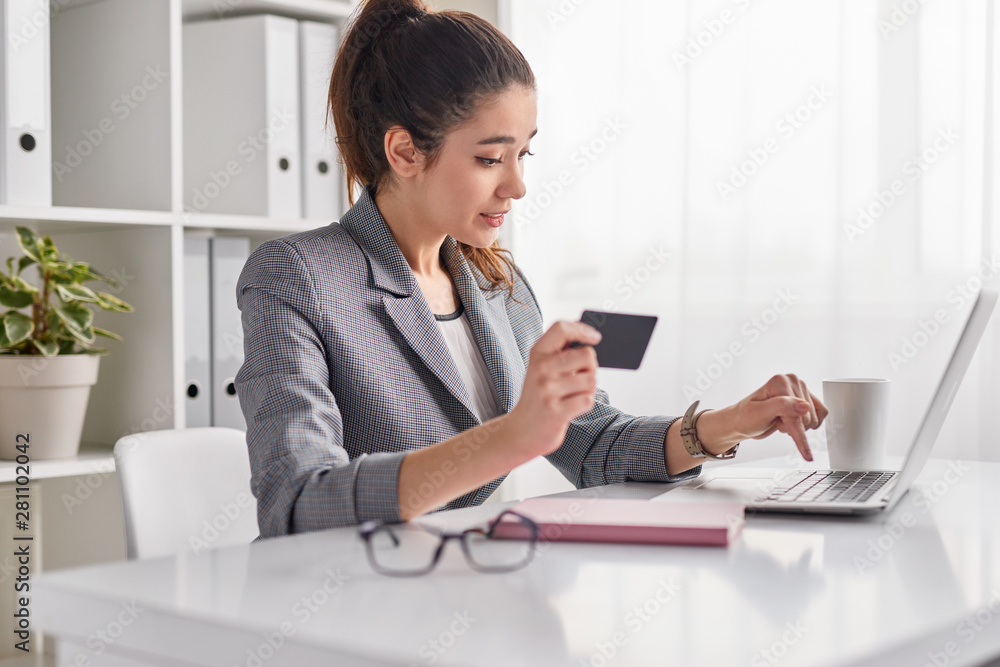 Young woman entering credit card credentials for online purchase Young woman entering credit card credentials for online purchase