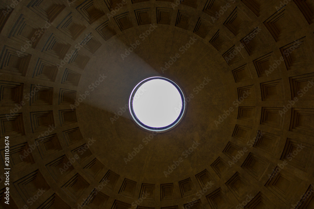 Rome, Italy - June 16 2019: An almost symetric portrait of the roof of the Pantheon in Rome, Italy. A big circular hole in the roof with stone crafted squares creating other circles around it.