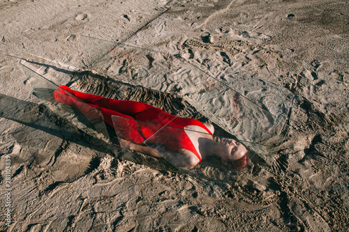 Young woman lying in glass coffin photo