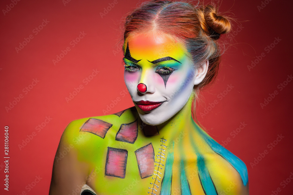 Fototapeta premium Lovely young lady with a face painting clown.