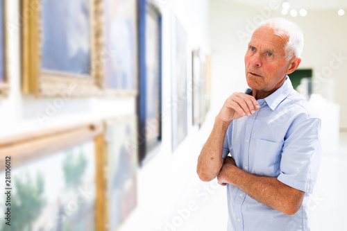 Man observing painting gallery