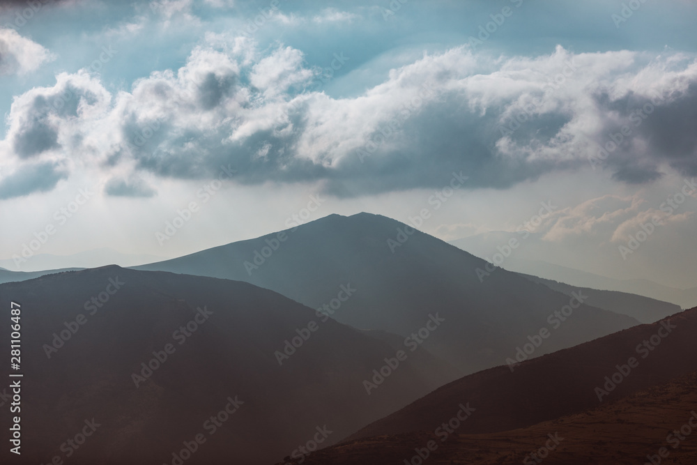 Landscape with sunset clouds between mountains. Landscape with sunset clouds between mountains.
