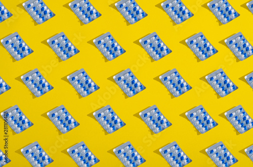 Collage blister blue capsule pharmasy on yellow background photo