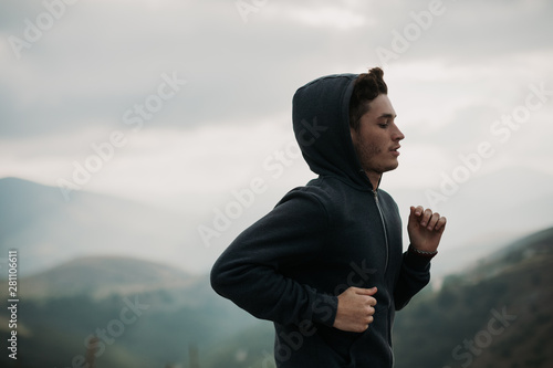 Side view of man jogging outdoors