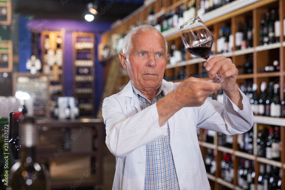 Winemaker checking wine in store