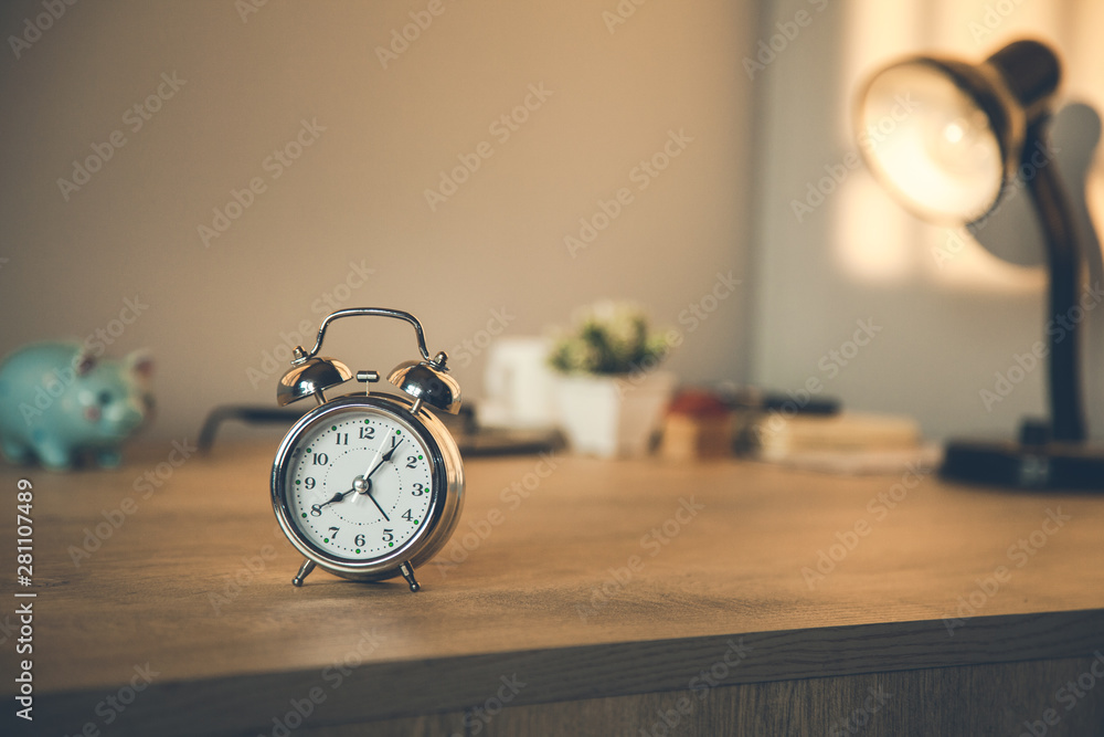 clock on the working wooden table clock on the working wooden table