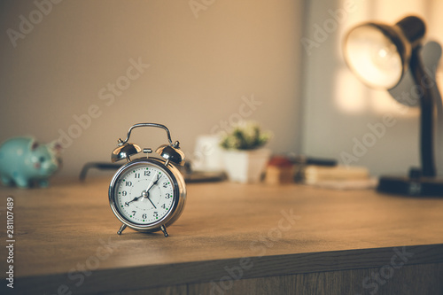  clock on the  working wooden  table