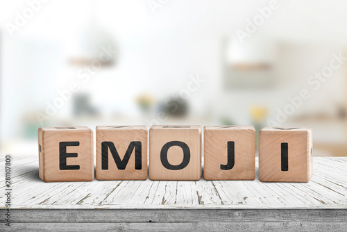 The word emoji on a wooden sign in a bright room