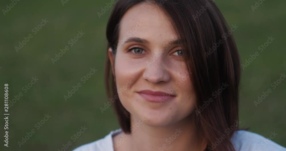 Sunset portrait of beautiful brunette young woman in autumn park. Girl smiling portrait outdoor Sunset portrait of beautiful brunette young woman in autumn park. Girl smiling portrait outdoor
