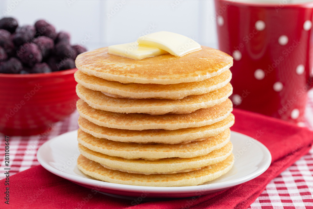 A Stack of Freshly Made Pancakes on a Gingham Tablecloth A Stack of Freshly Made Pancakes on a Gingham Tablecloth