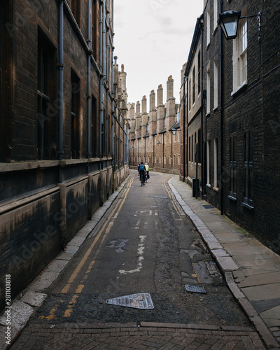 Cyclists in the back alley of an old town in England photo