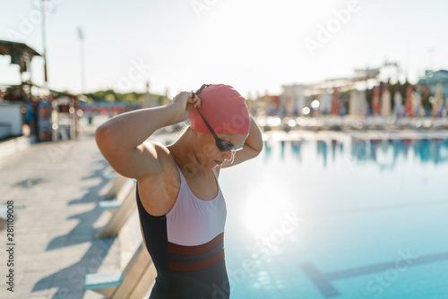 Swimmer wearing goggles near swimming pool photo