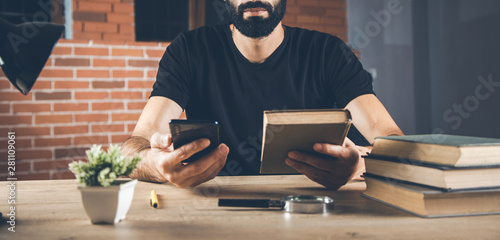 man hand phone with book on desk