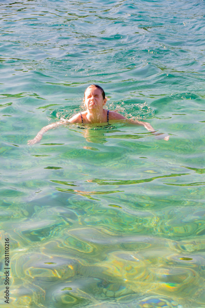 Young girl swiming in the sea