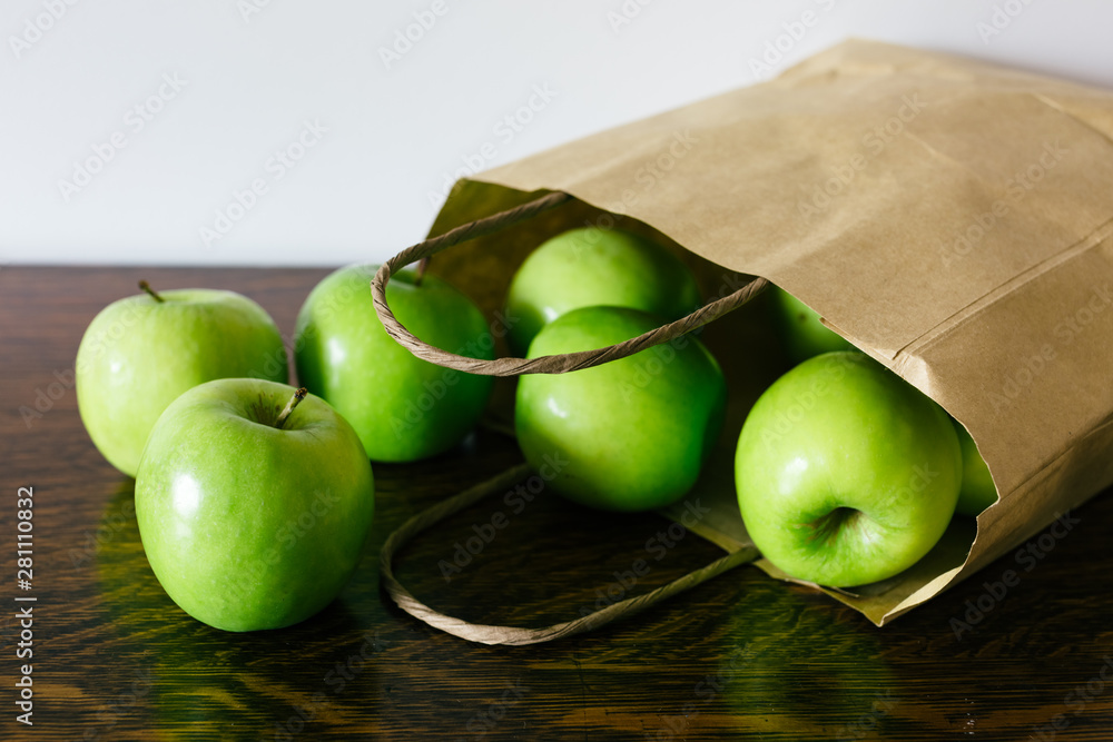 Green apples in brown paper bag Stock Photo | Adobe Stock