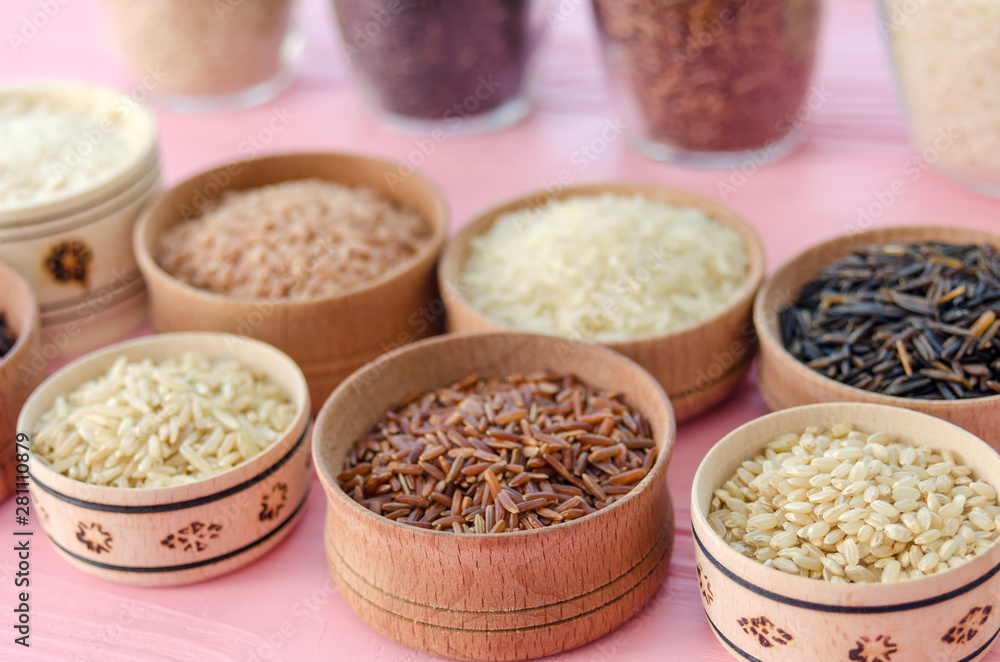 Assortment of different rice in bowls: white rice red rice black rice a mixture of wild and brown rice. Assortment of different rice in bowls: white rice red rice black rice a mixture of wild and brown rice.