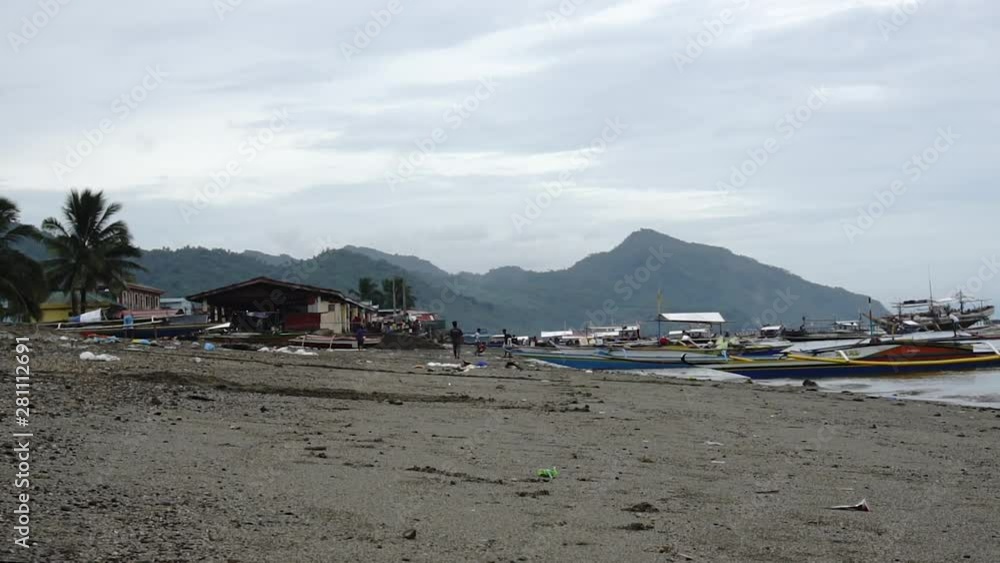 People walking with tons of garbage near the shoreline People walking with tons of garbage near the shoreline