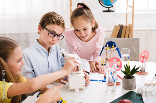 Stem education. Kids creating robots at school photo