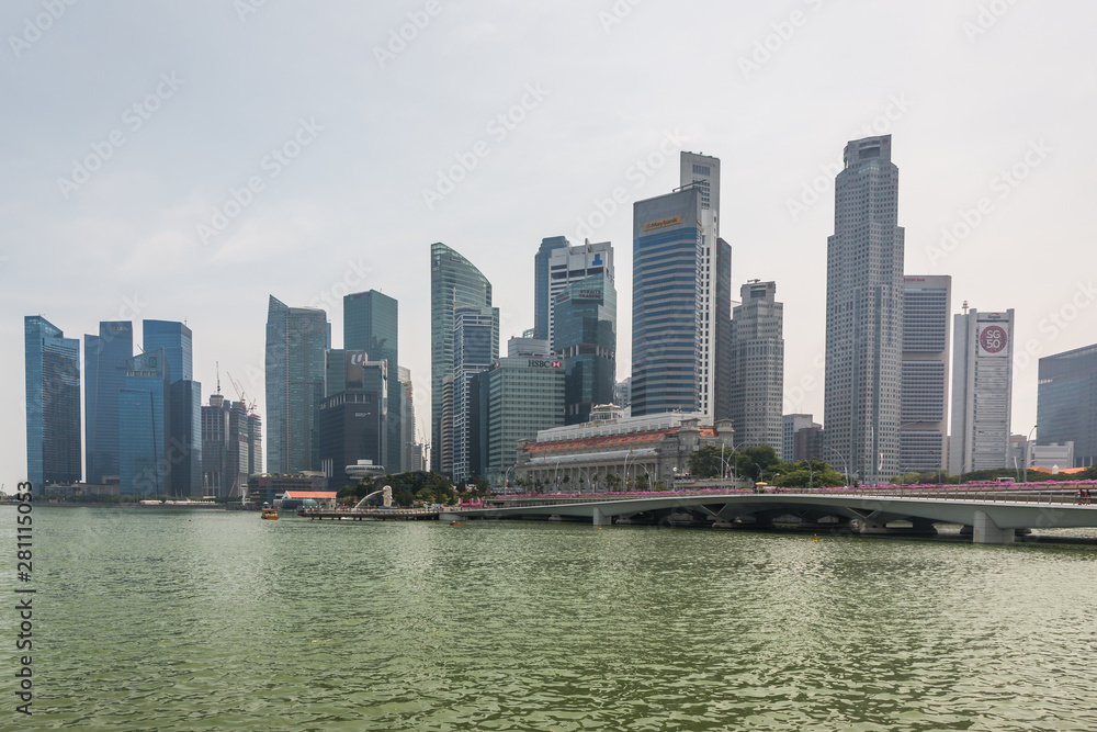 View over the Singapore River towards the Singapore skyline in the day time with high rise buildings, offices and skyscrapers in Singapore, Asia