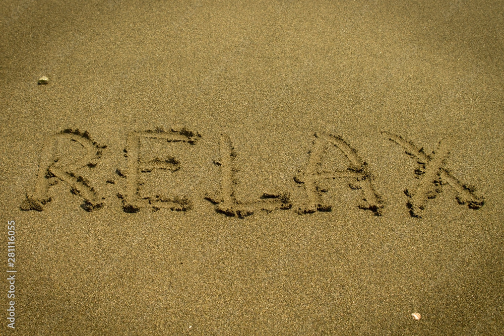 Fototapeta premium Word Relax written on the sand
