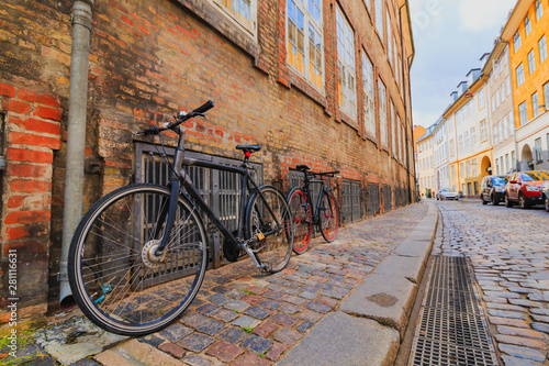 Two locked bicycycles in Copenhagen colorful old town street