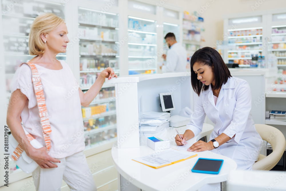Serious client waiting for her package of pills Serious client waiting for her package of pills