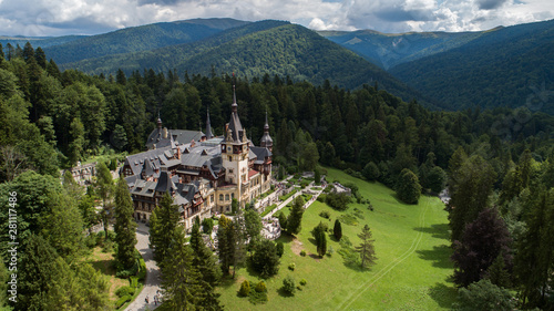 Aerial view of a castle in a forest on a sunny day 