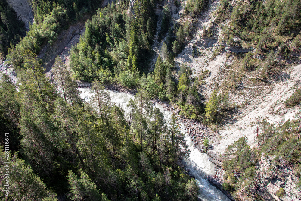 View of a wild rauen ravine with wild river in the Village Davos Wiesen, Swiss Alps