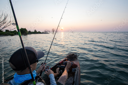 Young Man Kayak Fishing at Sunrise in Canada