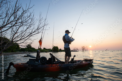 Young Man Kayak Fishing at Sunrise in Canada